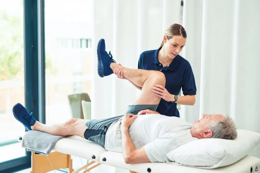 Physiotherapist assisting a patient with muscle recovery exercises Halesowen