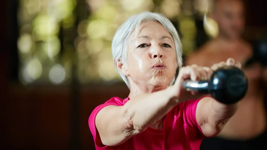 Toning Bingo Wings: Effective Exercises and Tips for Achieving Sleeker Arms 2 Person performing arm exercises with dumbbells Halesowen